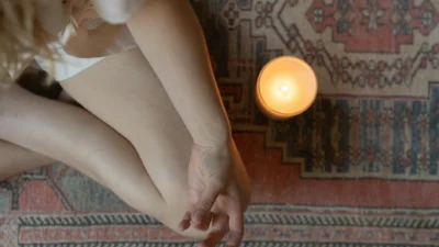 Close-up of candle wax removal from carpet showing wax residue versus dye stain