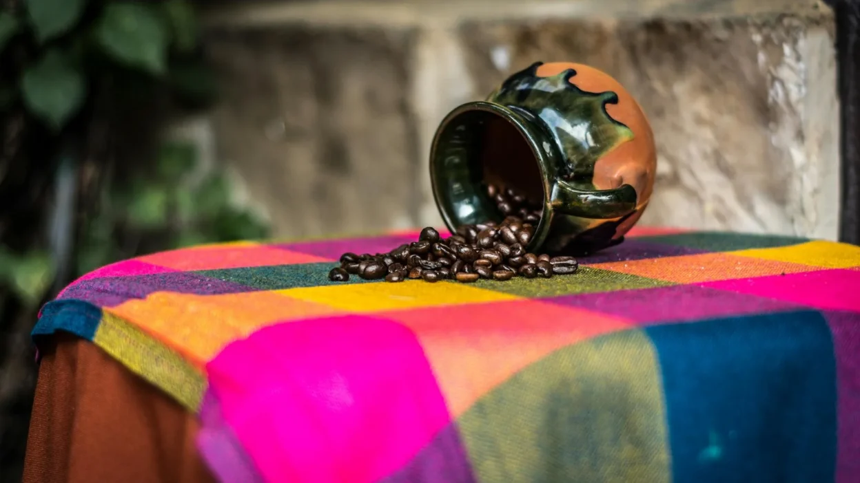 Cleaning coffee spills on cloth and leatherette car seats with microfiber cloth and spray.