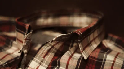 Close-up of a man's shirt collar with body oil stains, showing effective cleaning techniques for different fabrics.