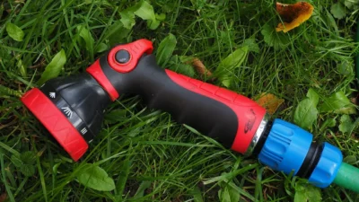 Close-up of white hard water stains and mineral spots on a clear shower glass door.