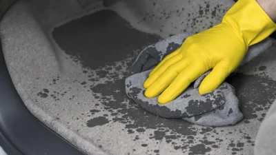 Close-up of muddy and salty car floor mats showing fresh stains versus dried, caked-on residue.
